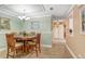 Well-lit dining area with a round table and chairs next to the kitchen at 8838 Coral Palms Ct # A, Kissimmee, FL 34747