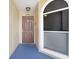 Exterior shot of a front door and entryway featuring address and storm door at 8838 Coral Palms Ct # A, Kissimmee, FL 34747