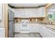 Bright kitchen with stainless steel refrigerator, white cabinets, and modern appliances at 8838 Coral Palms Ct # A, Kissimmee, FL 34747