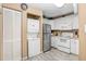Well-lit kitchen featuring white cabinets, stainless steel appliances, and in-unit laundry at 8838 Coral Palms Ct # A, Kissimmee, FL 34747