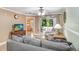 Comfortable living room featuring neutral tones, balcony access, and wood flooring at 8838 Coral Palms Ct # A, Kissimmee, FL 34747