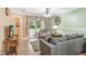Cozy living room with a ceiling fan, balcony access, and comfortable seating at 8838 Coral Palms Ct # A, Kissimmee, FL 34747