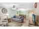Spacious living room with hardwood floors, comfortable seating, and a view into the dining area at 8838 Coral Palms Ct # A, Kissimmee, FL 34747