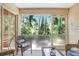 Relaxing patio with wicker furniture and views of a lush green forest at 8838 Coral Palms Ct # A, Kissimmee, FL 34747