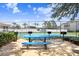 Community picnic tables and barbeque grills next to the tennis court for outdoor community recreation at 8838 Coral Palms Ct # A, Kissimmee, FL 34747