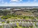Expansive aerial view of a residential community with nearby green spaces and a lake at 1049 Stoney Creek Dr, Lakeland, FL 33811