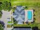 Aerial view of a home highlighting a backyard pool, ample parking and lush landscaping at 1049 Stoney Creek Dr, Lakeland, FL 33811