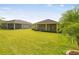 Expansive backyard features lush green lawn and screened in patios, perfect for outdoor enjoyment at 1049 Stoney Creek Dr, Lakeland, FL 33811