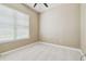 Cozy bedroom with soft carpet, a window with blinds, and neutral wall color at 1049 Stoney Creek Dr, Lakeland, FL 33811