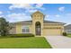 Charming single-story home featuring a well-manicured lawn and a two-car garage at 1049 Stoney Creek Dr, Lakeland, FL 33811