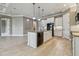 Open kitchen with white cabinets, granite countertops and island, perfect for entertaining at 1049 Stoney Creek Dr, Lakeland, FL 33811