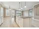 Open kitchen features granite countertops, an island with seating and plenty of natural light at 1049 Stoney Creek Dr, Lakeland, FL 33811