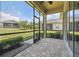 Screened in lanai with brick paver flooring overlooking a large backyard at 1049 Stoney Creek Dr, Lakeland, FL 33811