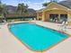 Community pool offering a refreshing retreat with lounge chairs and ample seating at 1049 Stoney Creek Dr, Lakeland, FL 33811