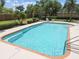 Inviting pool area with lounge chairs and lush landscaping for relaxation at 1049 Stoney Creek Dr, Lakeland, FL 33811