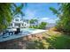 Backyard view showcasing the pool, lush lawn, seating area, and manicured landscaping at 112 Hiawatha Trl, Lakeland, FL 33803