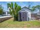 View of the shed, pool equipment, and partial view of the pool and main house at 112 Hiawatha Trl, Lakeland, FL 33803