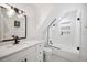 Modern bathroom featuring a sleek white vanity, mosaic floors, and a shower with glass enclosure at 112 Hiawatha Trl, Lakeland, FL 33803
