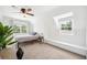 Bright bedroom featuring neutral carpeting, window bench, and a large window with tree views at 112 Hiawatha Trl, Lakeland, FL 33803
