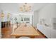 Open concept dining room with modern lighting, hardwood floors and bright, white walls at 112 Hiawatha Trl, Lakeland, FL 33803