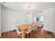 Inviting dining room with hardwood floors and an open view into the bright living room at 112 Hiawatha Trl, Lakeland, FL 33803