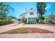 Charming two-story home with a red brick circular driveway and landscaped front yard at 112 Hiawatha Trl, Lakeland, FL 33803