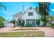 Charming two-story home with a red brick circular driveway and landscaped front yard at 112 Hiawatha Trl, Lakeland, FL 33803