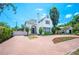 Charming two-story home with a red brick circular driveway and landscaped front yard at 112 Hiawatha Trl, Lakeland, FL 33803