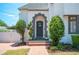 Close up of front entrance with arched doorway and landscaped surroundings at 112 Hiawatha Trl, Lakeland, FL 33803