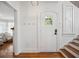 Inviting front entry featuring hardwood floors, white door with a window and staircase at 112 Hiawatha Trl, Lakeland, FL 33803