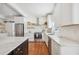 Updated kitchen featuring white cabinets, stainless steel appliances, marble countertops, and a black island at 112 Hiawatha Trl, Lakeland, FL 33803