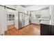 Updated kitchen with stainless steel appliances, white cabinets, and a sliding barn door for added charm at 112 Hiawatha Trl, Lakeland, FL 33803