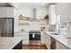 Bright kitchen featuring stainless steel appliances, white cabinets, marble countertops, and open shelving at 112 Hiawatha Trl, Lakeland, FL 33803