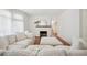 Bright living room featuring a large white sofa, fireplace, and lots of natural light at 112 Hiawatha Trl, Lakeland, FL 33803