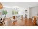 Bright living space with hardwood floors, white walls, and an open layout to the dining and kitchen areas at 112 Hiawatha Trl, Lakeland, FL 33803