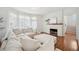 Bright living room featuring a large white sofa, fireplace, and lots of natural light at 112 Hiawatha Trl, Lakeland, FL 33803