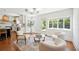Bright living room boasts hardwood floors, three plush chairs, and view of backyard pool at 112 Hiawatha Trl, Lakeland, FL 33803