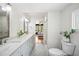 Bright and airy main bathroom with dual sinks, walk in shower and patterned tile flooring at 112 Hiawatha Trl, Lakeland, FL 33803