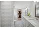 Sleek main bathroom with subway tile shower, double vanity, and stylish tile flooring at 112 Hiawatha Trl, Lakeland, FL 33803