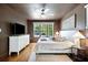 Elegant main bedroom with hardwood floors, neutral tones and views of the backyard at 112 Hiawatha Trl, Lakeland, FL 33803