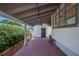Covered brick patio with access to backyard, side door, and ample space at 112 Hiawatha Trl, Lakeland, FL 33803