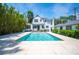 Backyard swimming pool with stone patio, perfect for outdoor entertaining at 112 Hiawatha Trl, Lakeland, FL 33803