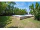 Tranquil pool setting with manicured lawn and privacy landscaping creates backyard oasis at 112 Hiawatha Trl, Lakeland, FL 33803