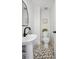 Modern powder room featuring a pedestal sink, and neutral hexagon floor tiles at 112 Hiawatha Trl, Lakeland, FL 33803