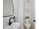 Modern powder room with a sleek sink, faucet, and decor at 112 Hiawatha Trl, Lakeland, FL 33803