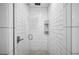 Modern shower featuring white subway tiles, mosaic floor, and built-in shelving niche at 112 Hiawatha Trl, Lakeland, FL 33803