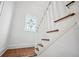 Elegant staircase with white railings, wood treads and stained glass window at 112 Hiawatha Trl, Lakeland, FL 33803