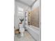 Cozy bathroom featuring tiled shower, shower curtain, toilet, and window at 117 Palmola St, Lakeland, FL 33803