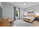 Serene bedroom with a neutral color scheme, large window, and tasteful decor at 117 Palmola St, Lakeland, FL 33803
