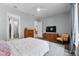 Bright bedroom features wood floors, a large window, and a calming color palette at 117 Palmola St, Lakeland, FL 33803
